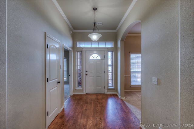 foyer entrance with dark hardwood / wood-style flooring and crown molding