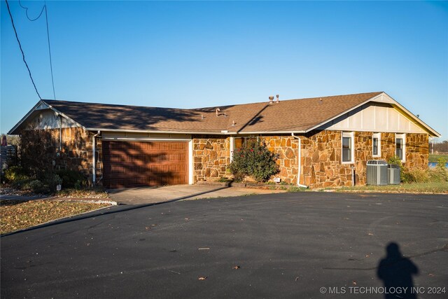 single story home with a garage and central AC