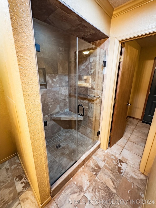 full bath with ornamental molding, a stall shower, and a textured wall