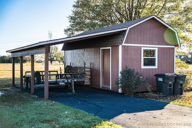 view of outbuilding featuring a yard