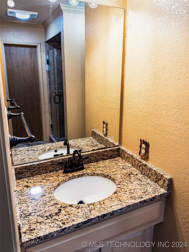 bathroom featuring vanity and a textured ceiling