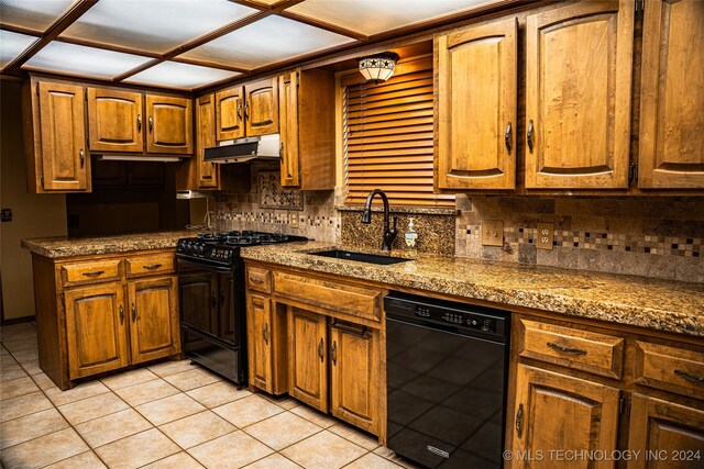 kitchen with black appliances, sink, tasteful backsplash, and light tile patterned floors