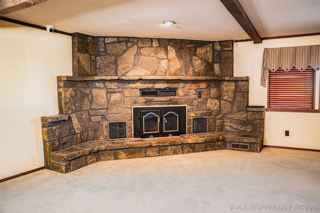 carpeted living room featuring visible vents, a stone fireplace, and beam ceiling