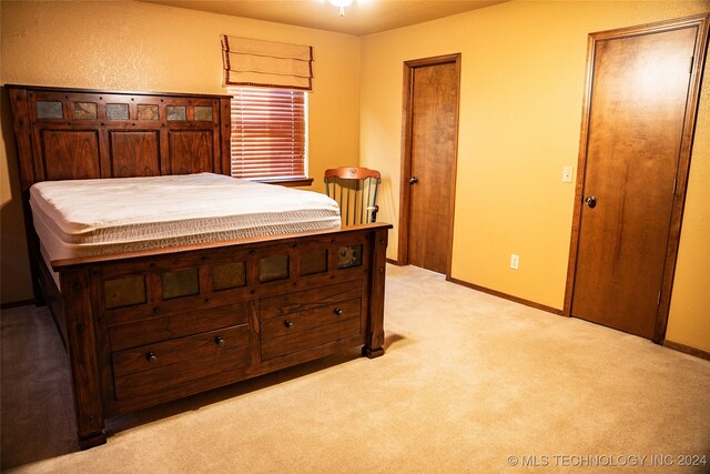 bedroom featuring light colored carpet