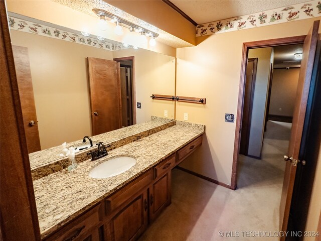 bathroom featuring vanity and a textured ceiling