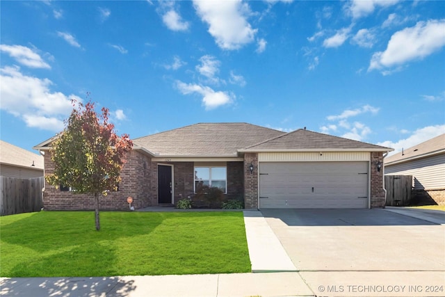 ranch-style house featuring a garage and a front lawn