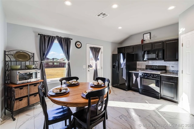 dining space with vaulted ceiling