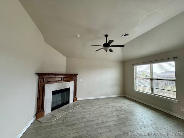 unfurnished living room with lofted ceiling, ceiling fan, and a fireplace