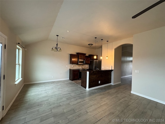 kitchen featuring dark brown cabinetry, appliances with stainless steel finishes, decorative light fixtures, and light hardwood / wood-style flooring