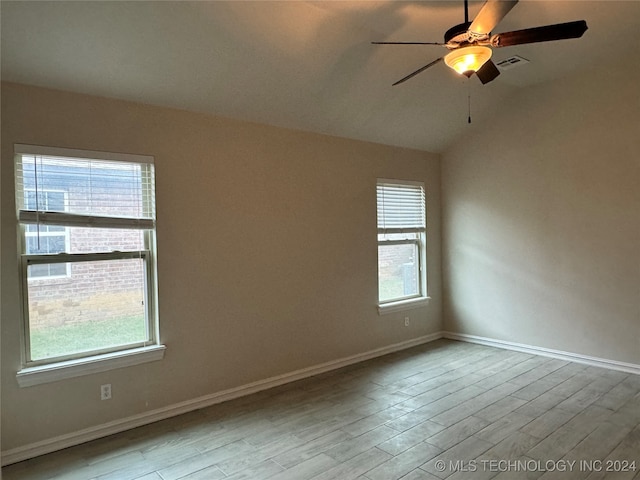 spare room featuring a wealth of natural light, ceiling fan, and light hardwood / wood-style flooring