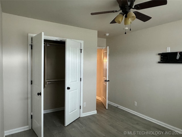 unfurnished bedroom with wood-type flooring, ceiling fan, and a closet