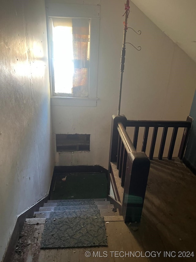 stairs featuring lofted ceiling