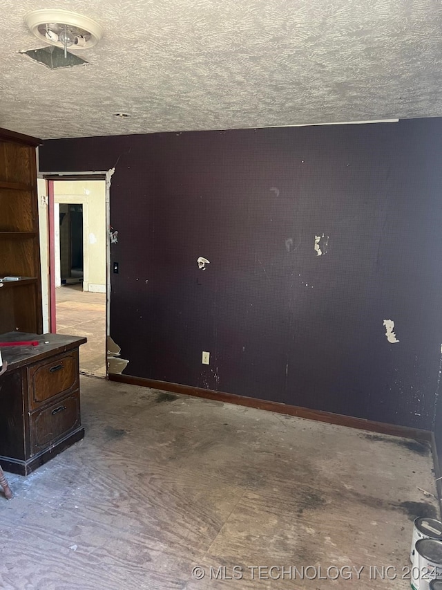 empty room with a textured ceiling