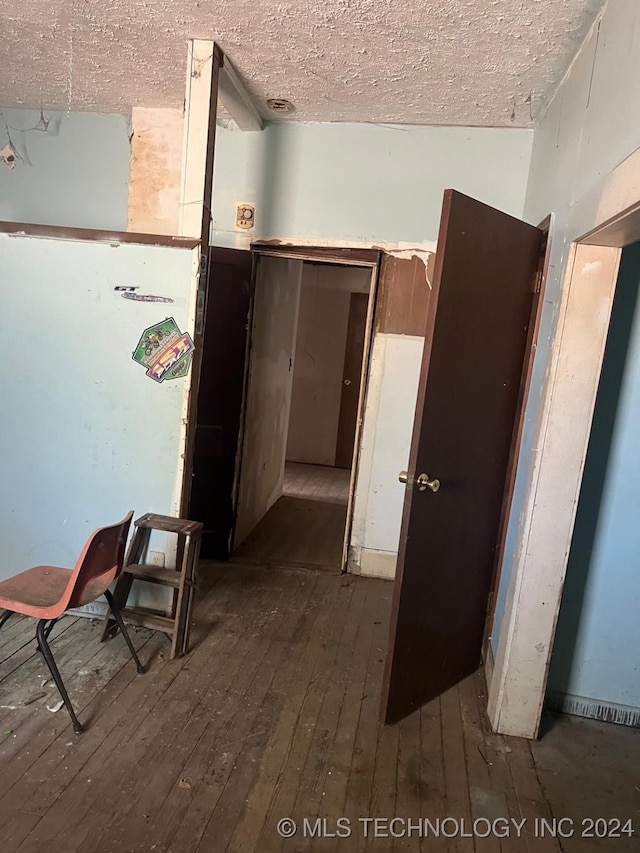 corridor with dark hardwood / wood-style flooring