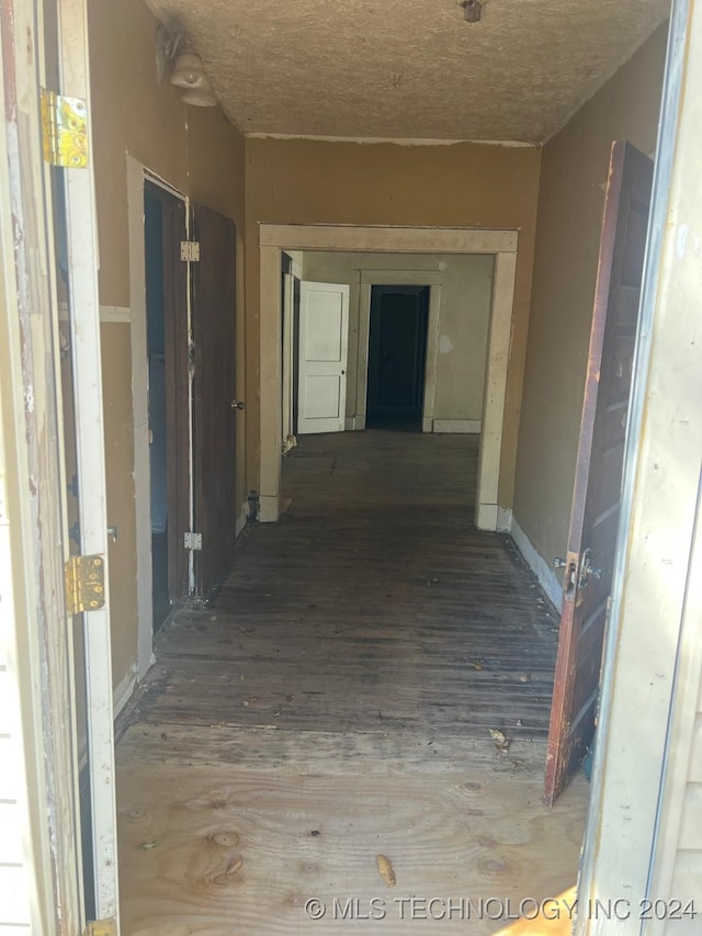 hallway with hardwood / wood-style flooring