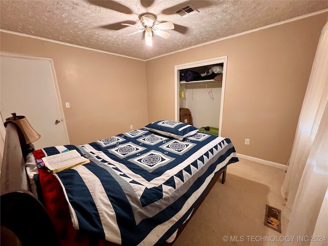 carpeted bedroom featuring a closet, a textured ceiling, and ceiling fan