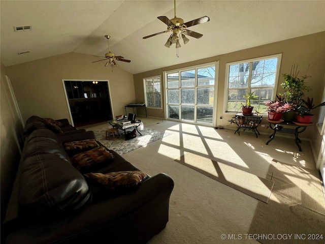 carpeted living room featuring ceiling fan and vaulted ceiling