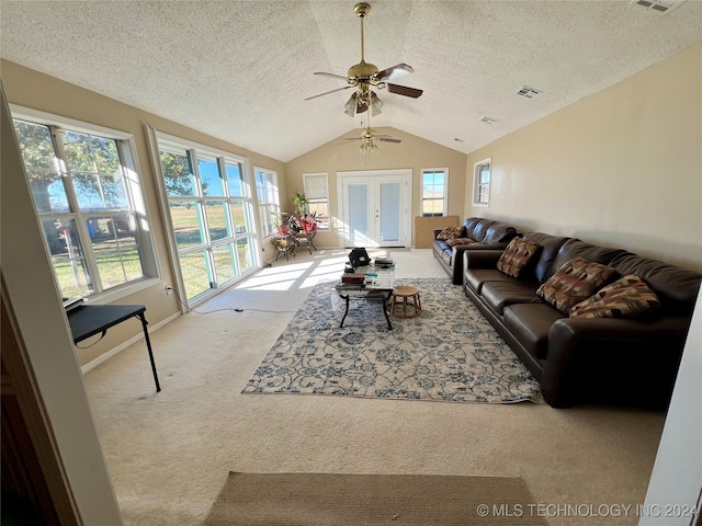 carpeted living room featuring a textured ceiling, lofted ceiling, and ceiling fan