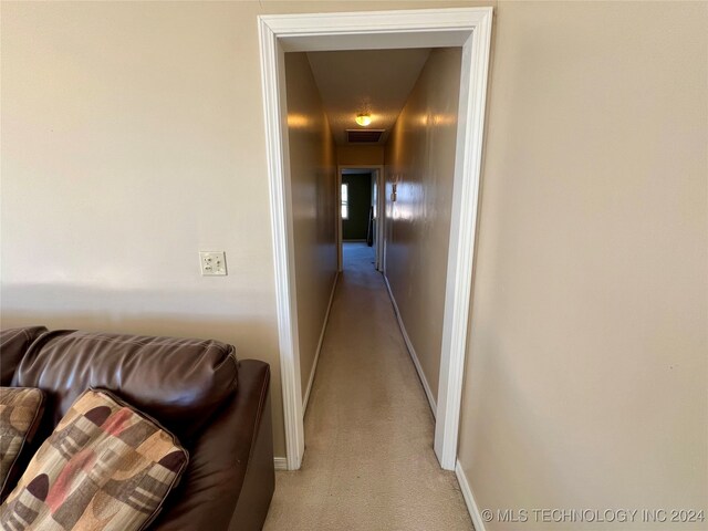 hall with light colored carpet