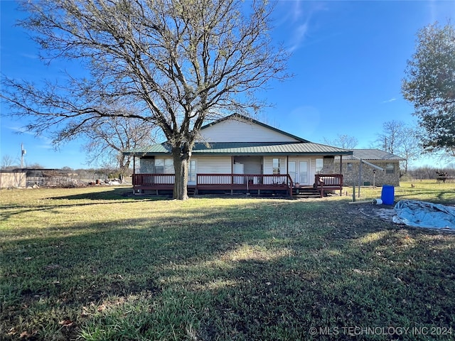 back of property featuring a yard