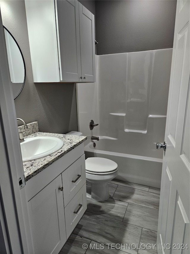 full bathroom with vanity, shower / bath combination, and toilet