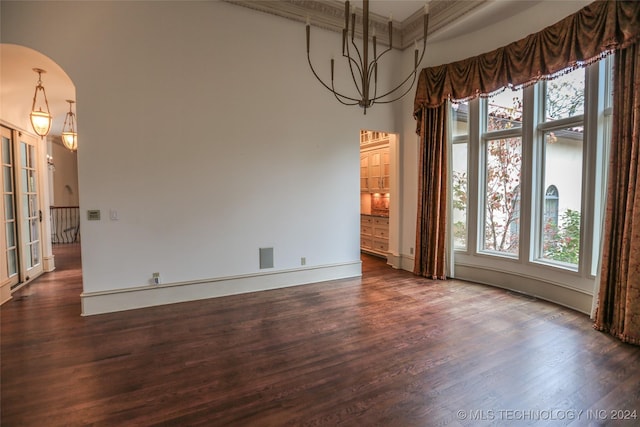 8403 S Allegheny Ave, Tulsa, OK 74137 - unfurnished dining area featuring healthy amount of natural light, dark wood-type flooring, a high ceiling, baseboards, and ornamental molding