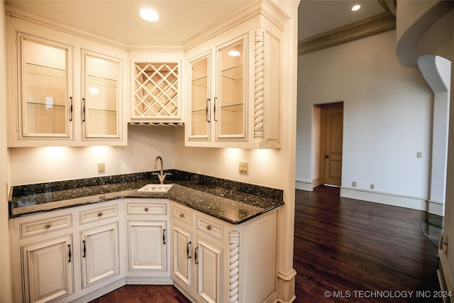 kitchen featuring dark wood-type flooring and dark stone counters