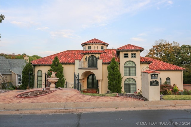 8403 S Allegheny Ave, Tulsa, OK 74137 - mediterranean / spanish home with a balcony, stucco siding, and a tiled roof