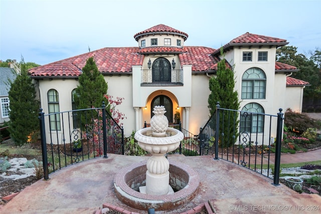 8403 S Allegheny Ave, Tulsa, OK 74137 - mediterranean / spanish-style house with stucco siding, a tile roof, and a balcony