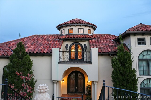 8403 S Allegheny Ave, Tulsa, OK 74137 - mediterranean / spanish house with a balcony, french doors, stucco siding, and a tiled roof