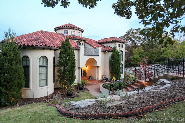 8403 S Allegheny Ave, Tulsa, OK 74137 - mediterranean / spanish-style home featuring a balcony, a tile roof, and stucco siding