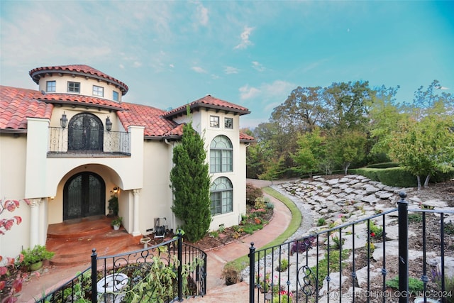 8403 S Allegheny Ave, Tulsa, OK 74137 - mediterranean / spanish-style house with french doors, a balcony, stucco siding, and a tile roof