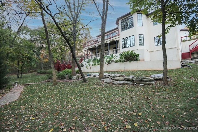 8403 S Allegheny Ave, Tulsa, OK 74137 - rear view of house featuring stairs, stucco siding, and a lawn