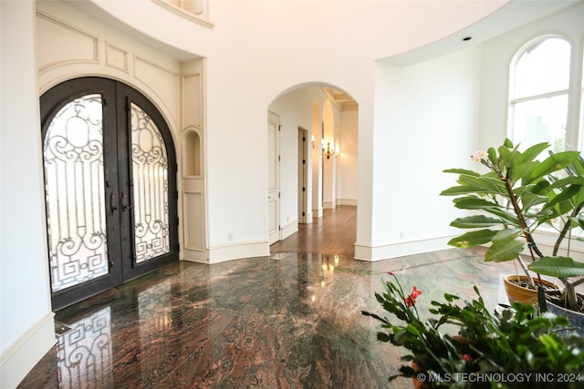 8403 S Allegheny Ave, Tulsa, OK 74137 - foyer entrance featuring arched walkways, french doors, baseboards, and a high ceiling
