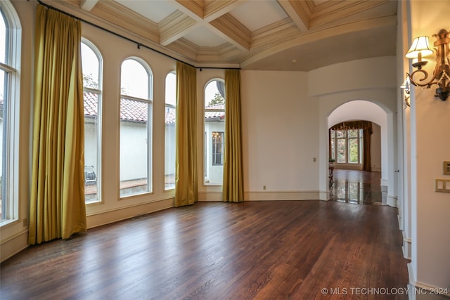 unfurnished room featuring beamed ceiling, dark hardwood / wood-style floors, ornamental molding, and coffered ceiling