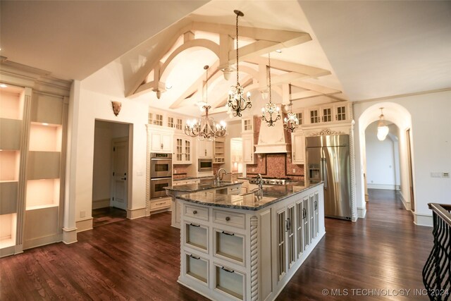 8403 S Allegheny Ave, Tulsa, OK 74137 - kitchen with stainless steel appliances, a large island, a chandelier, arched walkways, and hanging light fixtures
