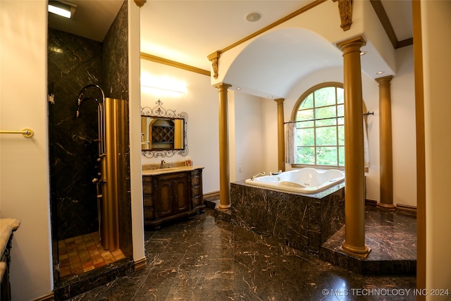 bathroom with tiled bath, vanity, ornate columns, and ornamental molding