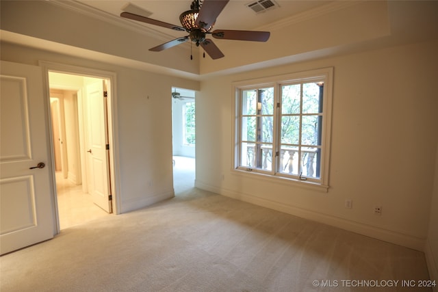 carpeted spare room featuring ceiling fan and crown molding