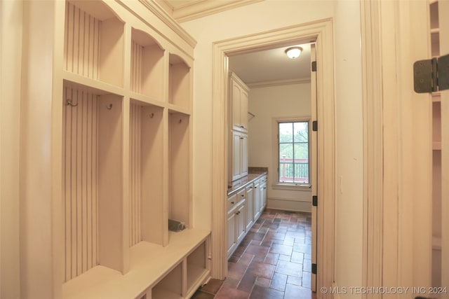 8403 S Allegheny Ave, Tulsa, OK 74137 - mudroom featuring stone finish flooring and crown molding