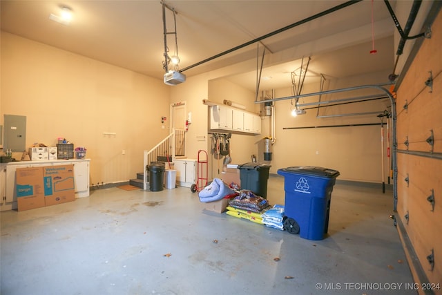 garage featuring electric panel and a garage door opener