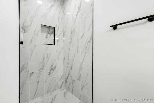 bathroom with tiled shower