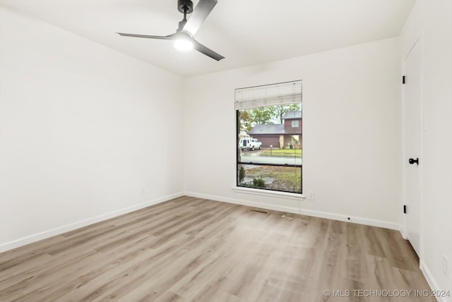 empty room featuring ceiling fan and light hardwood / wood-style floors