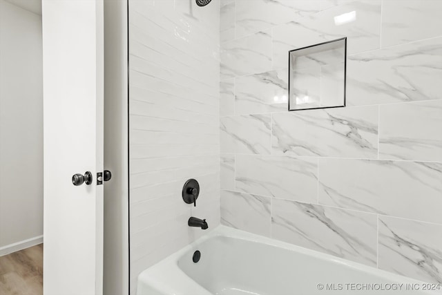 bathroom featuring hardwood / wood-style flooring and tiled shower / bath combo