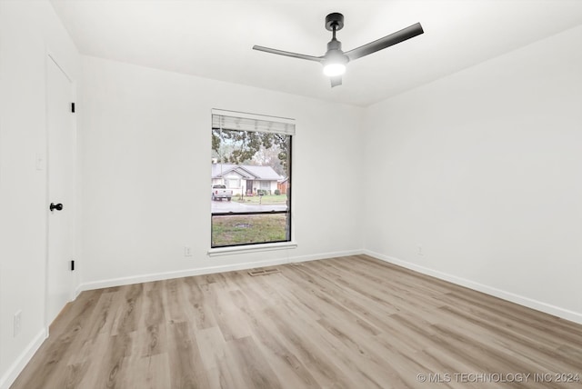 spare room with light wood-type flooring and ceiling fan