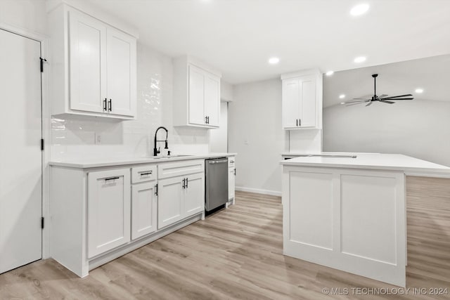 kitchen featuring ceiling fan, stainless steel dishwasher, a kitchen island, white cabinets, and light wood-type flooring