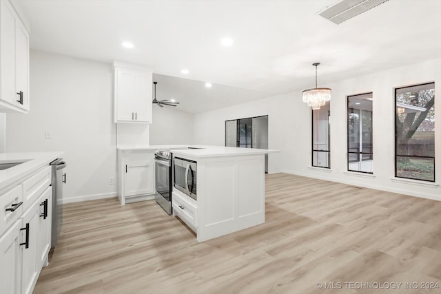 kitchen with white cabinetry, stainless steel appliances, and light hardwood / wood-style flooring