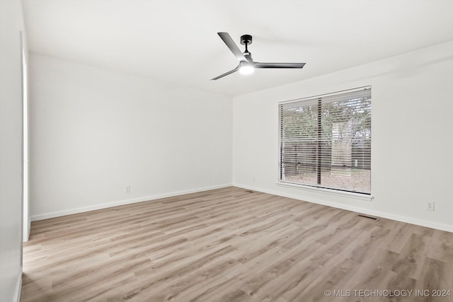 empty room featuring ceiling fan and light wood-type flooring