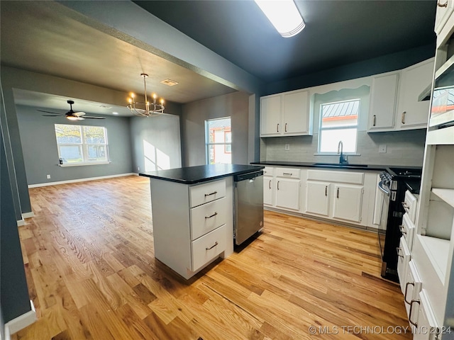 kitchen featuring plenty of natural light, white cabinets, and appliances with stainless steel finishes