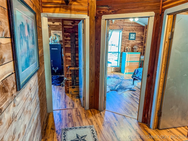 hallway featuring wood walls and wood-type flooring