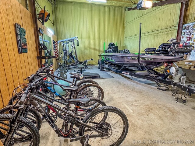 garage featuring a garage door opener and wood walls